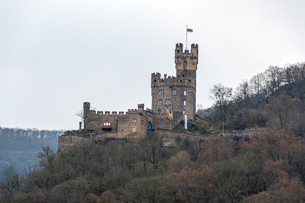 The image shows Sooneck Castle (Burg Sooneck), a medieval fortress located in the Rhine Gorge near Niederheimbach, Germany. AMA Waterways Rhine River cruise